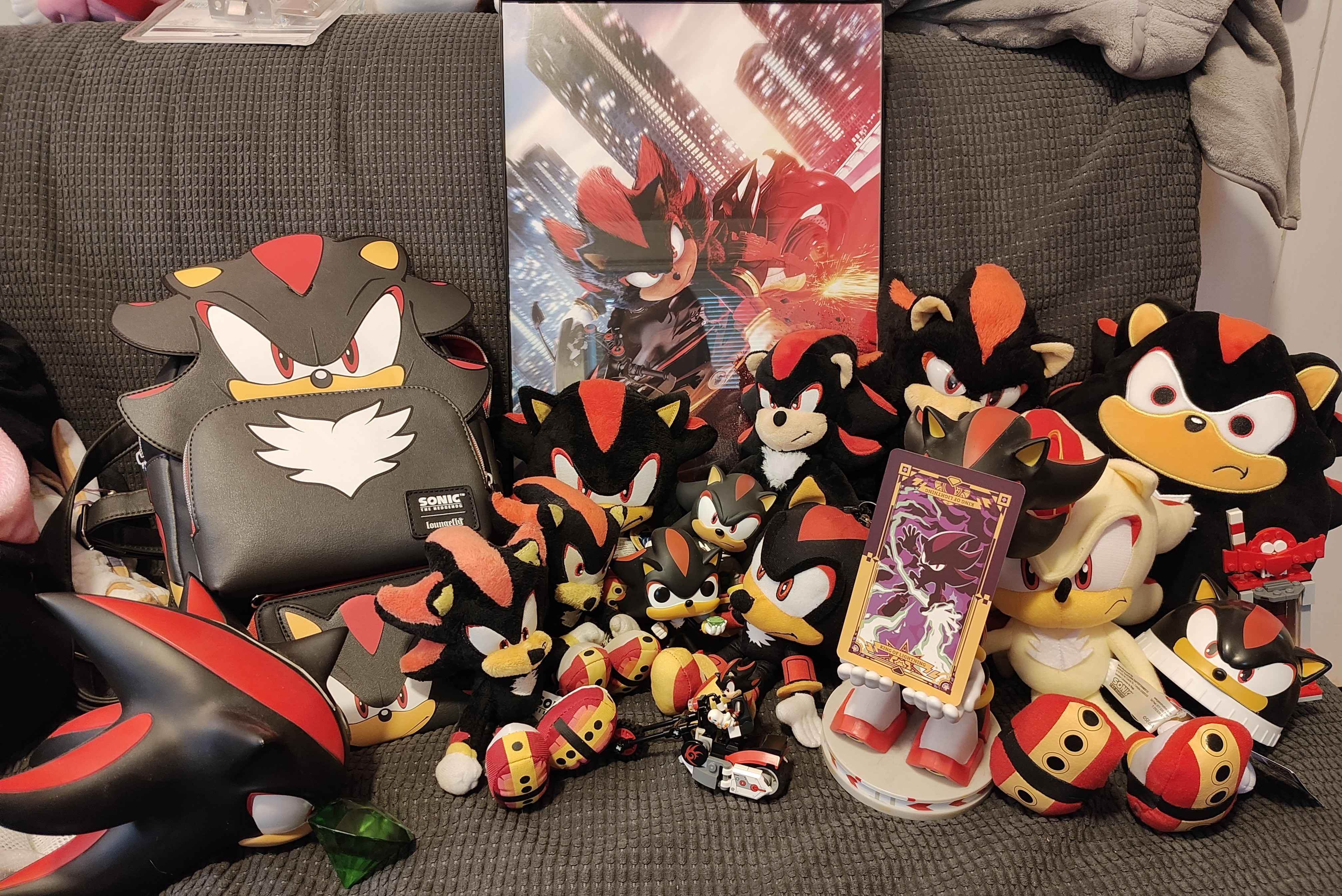 a truly massive collection of shadow the hedgehog plushies. like modestly so, though. it takes up half of a loveseat